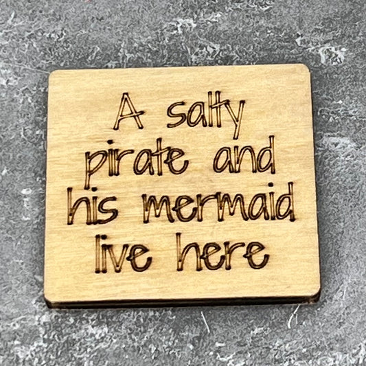 2" wood square with “A salty pirate and his mermaid live here.“ laser engraved