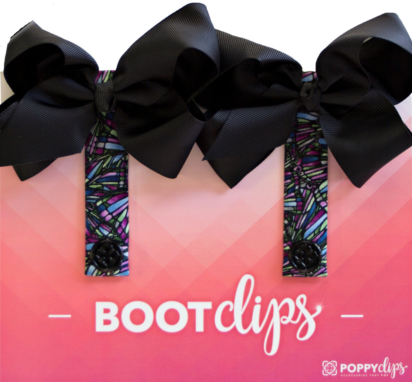 7 ¾” long by 7/8” wide multicolored material in blues, greens, and purples, with a magnet at each end. The outer magnet is a decorative black medallion with the company logo. At the top is double black bow that is approximately 4” across.