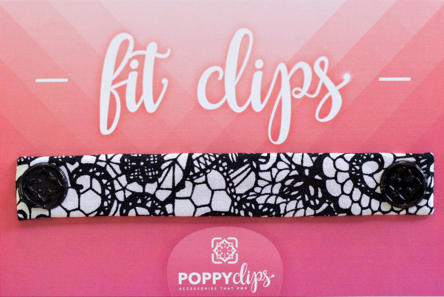 5 ¼” long by 7/8” wide white material with a black lace design, and with a magnet at each end. The outer magnets are a decorative black medallion with the company logo.