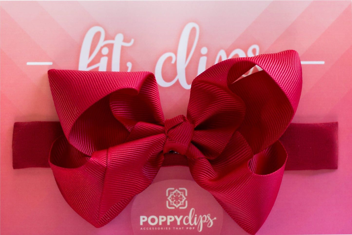 5 ¼” long by 7/8” wide red material with hidden magnets at each end. Centered on the outside is a double red bow that is approximately 4” across.