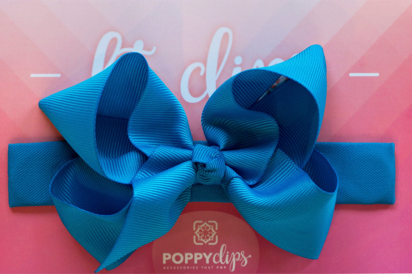 5 ¼” long by 7/8” wide ocean blue material with hidden magnets at each end. Centered on the outside is a double ocean blue bow that is approximately 4” across.
