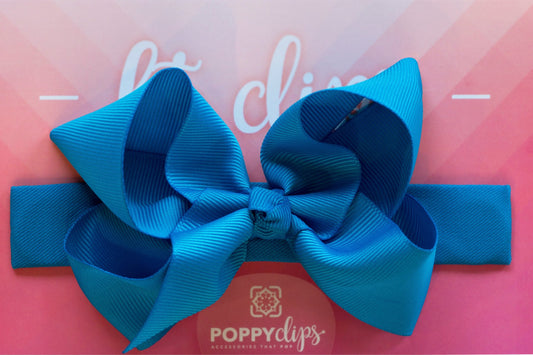 5 ¼” long by 7/8” wide ocean blue material with hidden magnets at each end.  Centered on the outside is a double ocean blue bow that is approximately 4” across.