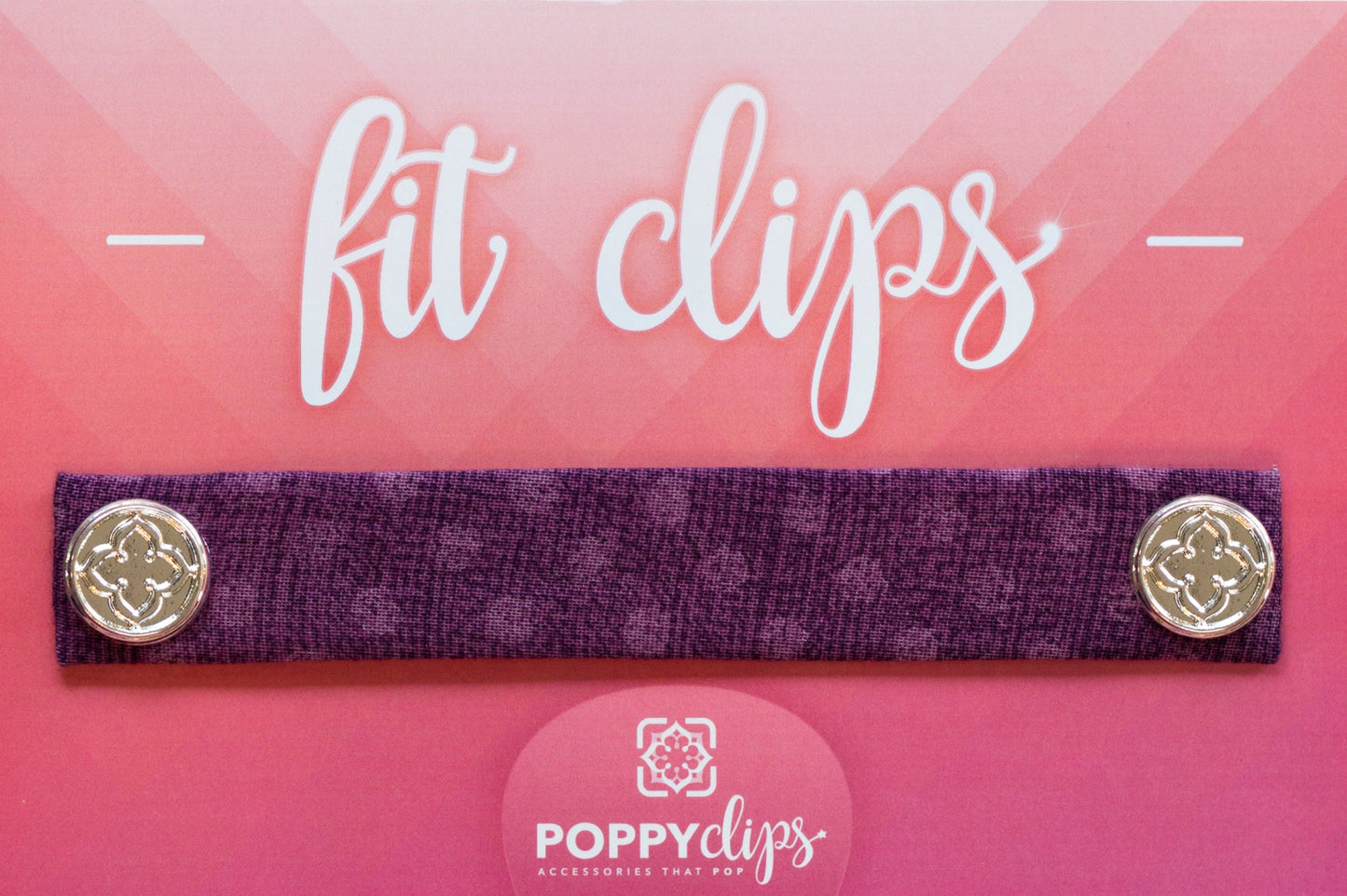 5 ¼” long by 7/8” wide purple material with lighter purple dots, and magnets at each end. The outer magnets are a decorative silver medallion with the company logo.