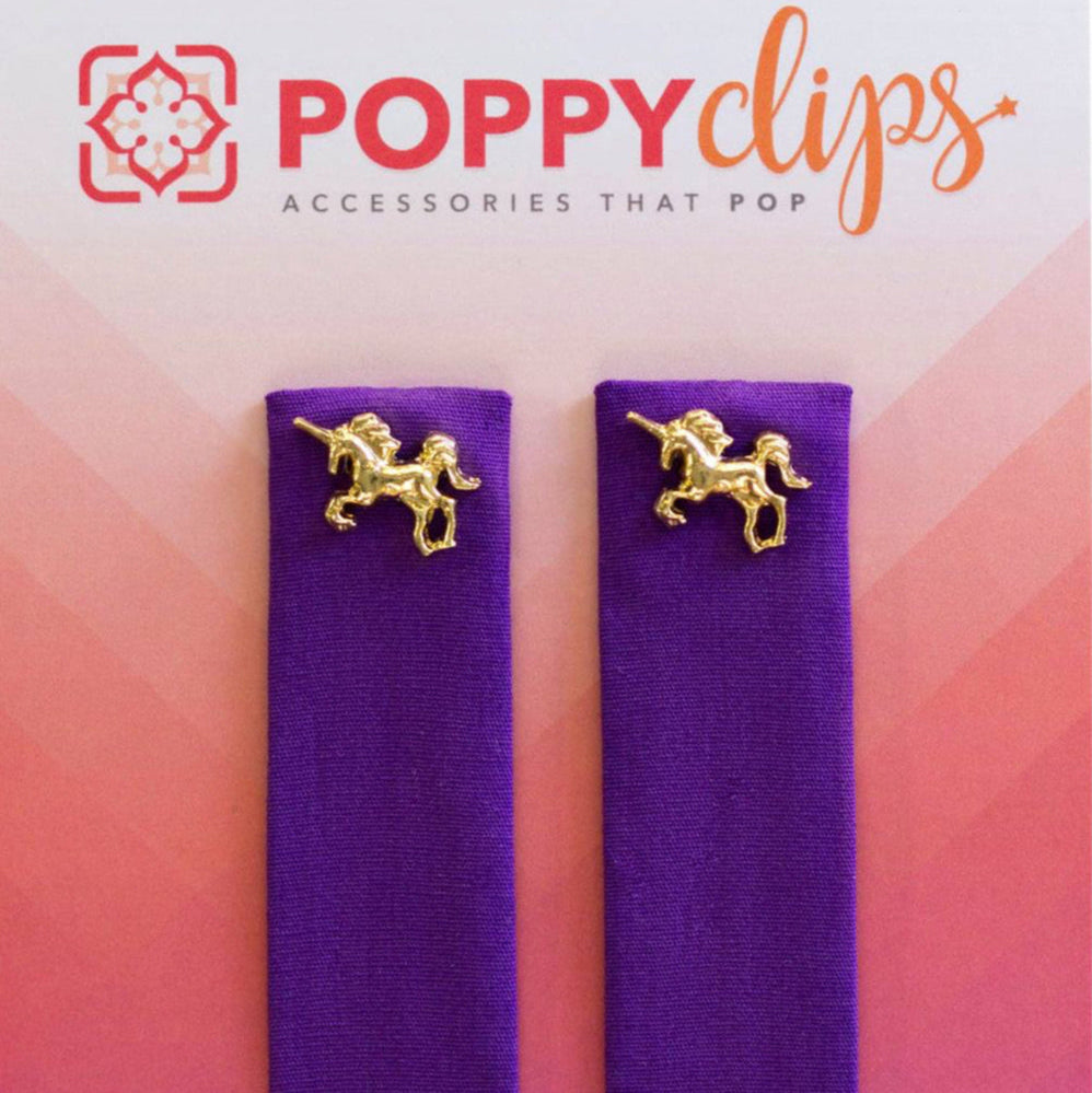 Two 5 ¼” long by 7/8” wide purple material with a magnet at each end. The outer magnet is a decorative gold unicorn.