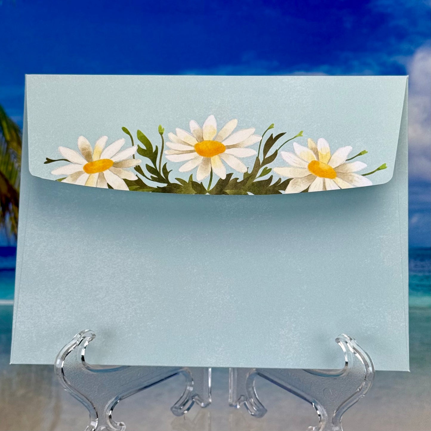 Envelope for the ‘Enjoy Your Special Day’ greeting card featuring cute daisies on the flap.