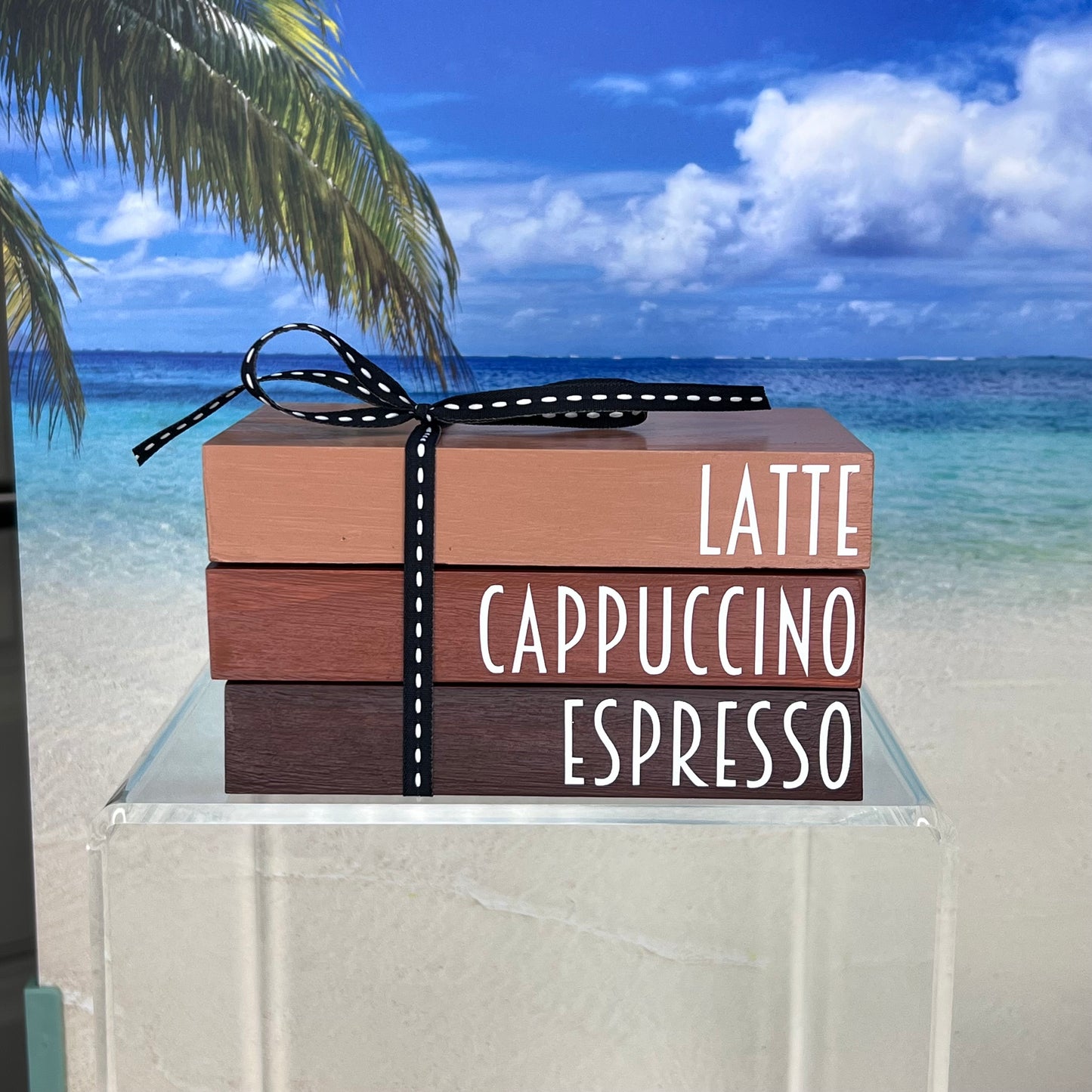 Decorative faux book stack in latte, cappuccino, and espresso tones — hand-painted pine wood with vinyl letters and coordinating ribbon, perfect for coffee lovers and stylish home displays.