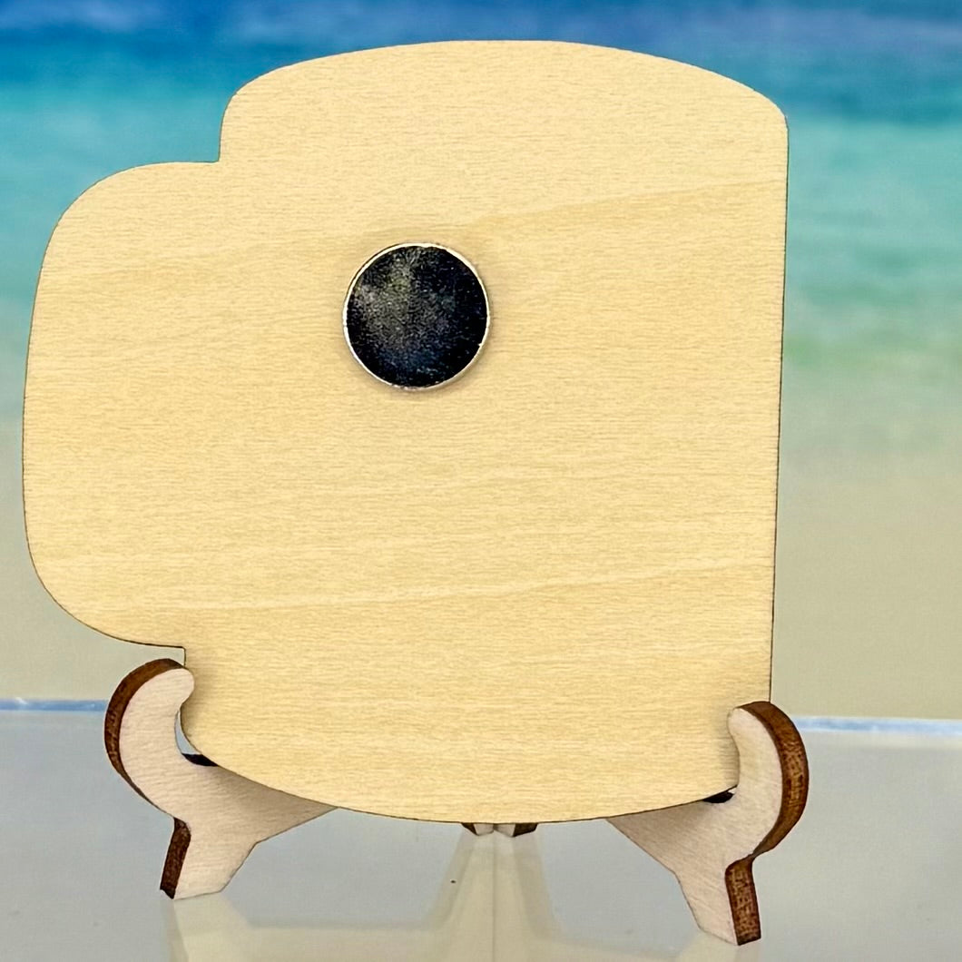 Back view of a laser-cut wooden fridge magnet showing smooth wood grain and a strong round magnet securely attached at the center.