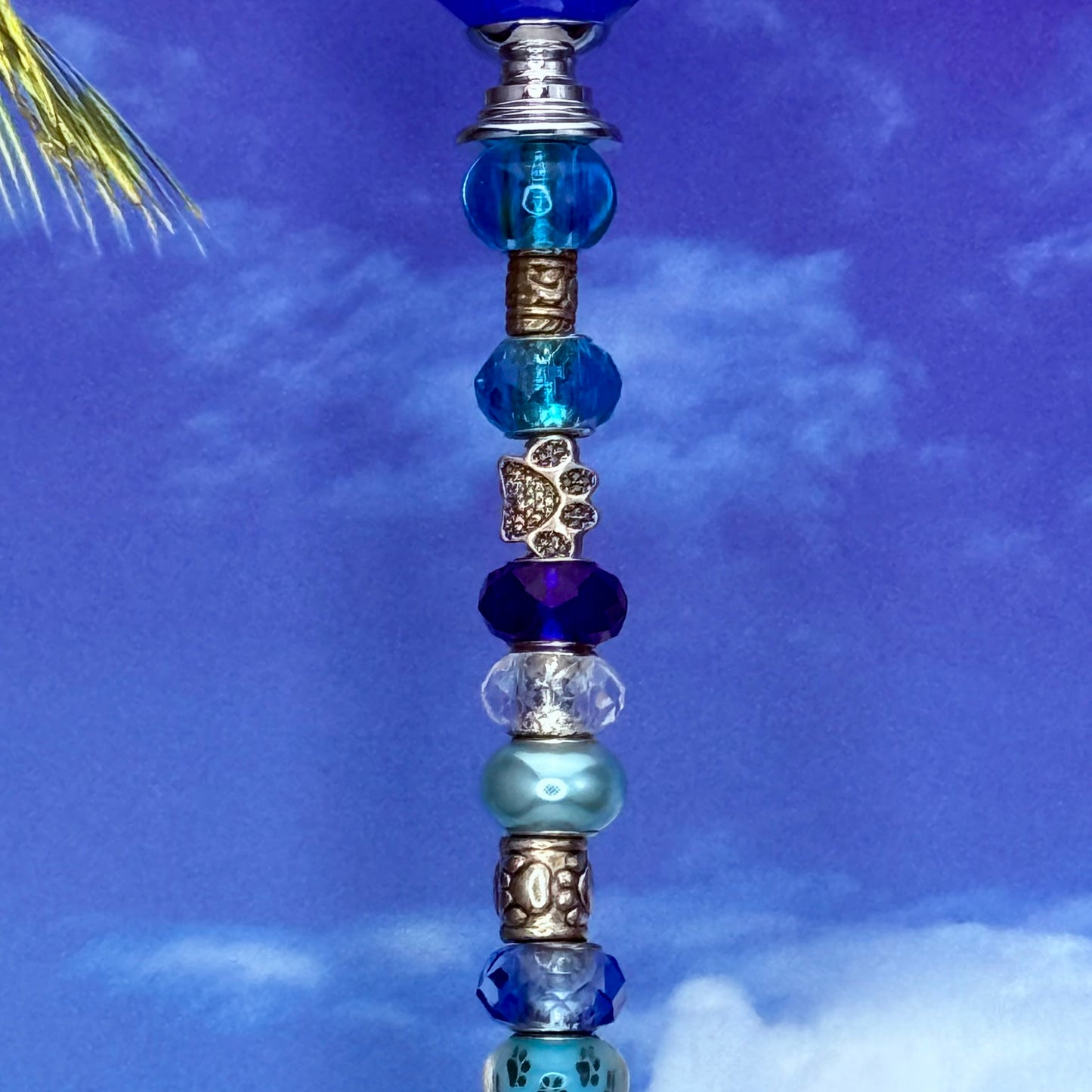 Blue aqua garden stake with paw print design — metal yard décor perfect for pet-friendly gardens.