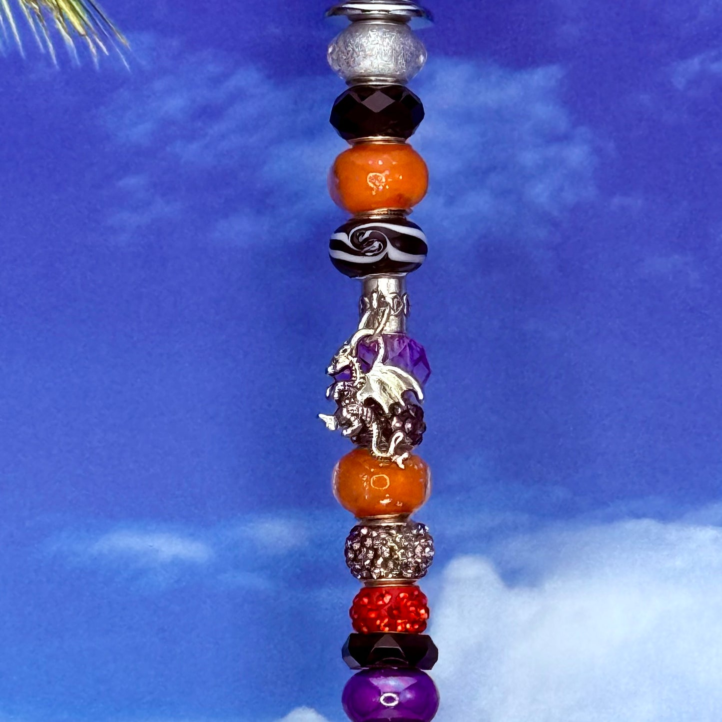 Fiery Twilight dragon garden stake — orange, purple, and black metal yard décor with fantasy design.