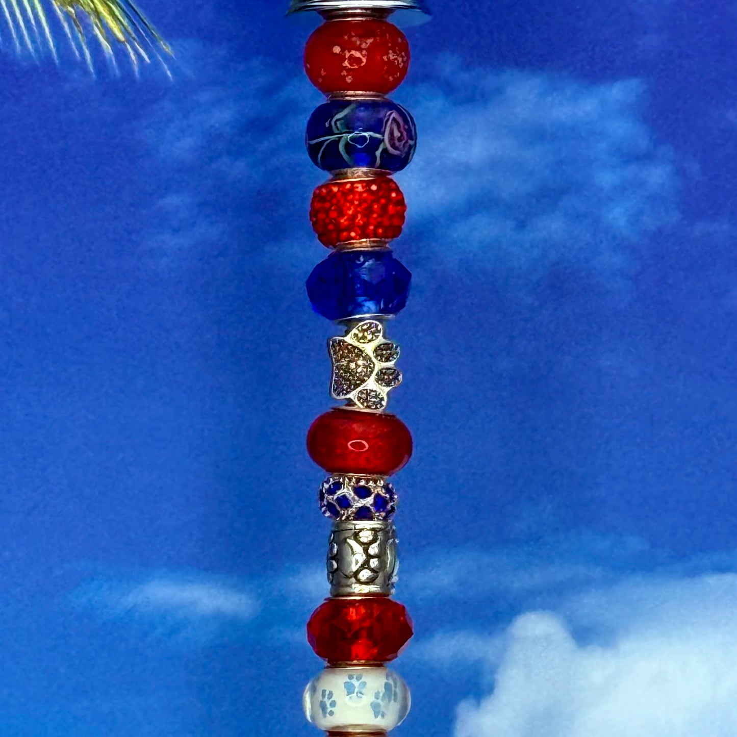 Red, white, and blue metal garden stake with paw print and ‘Pawtriot Pride’ — patriotic pet-themed yard décor.