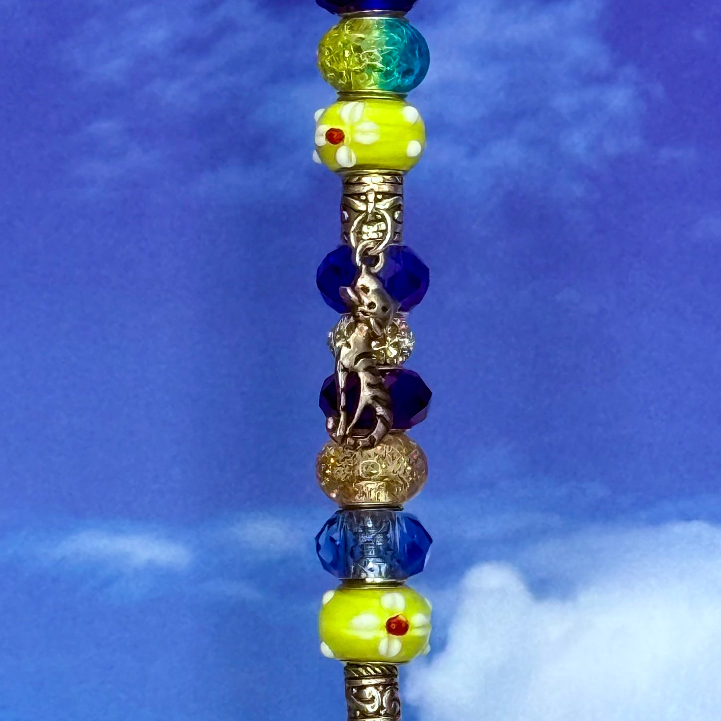 Blue metal garden stake with a sunny cat silhouette — whimsical pet‑themed outdoor décor.