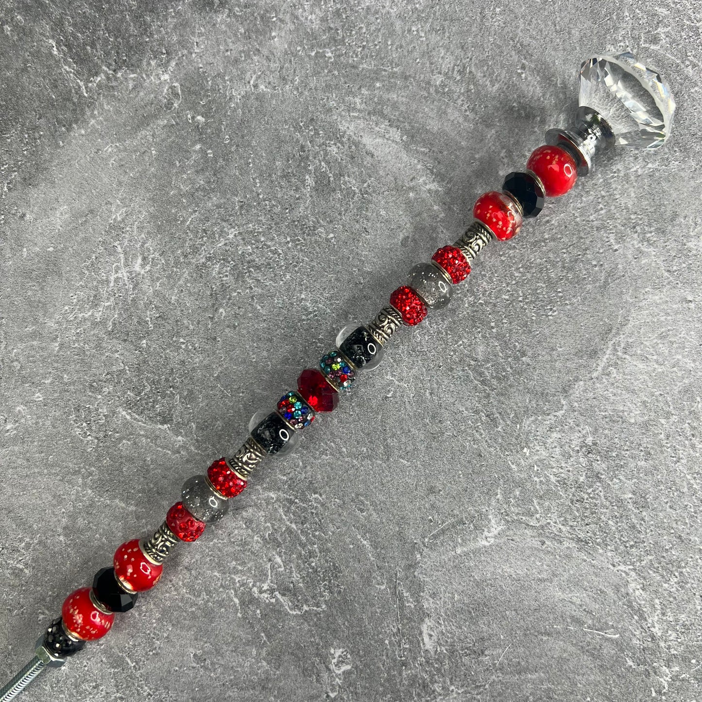 Red and black metal garden stake ‘Ruby Delight’ with jeweled topper — elegant handcrafted garden décor.