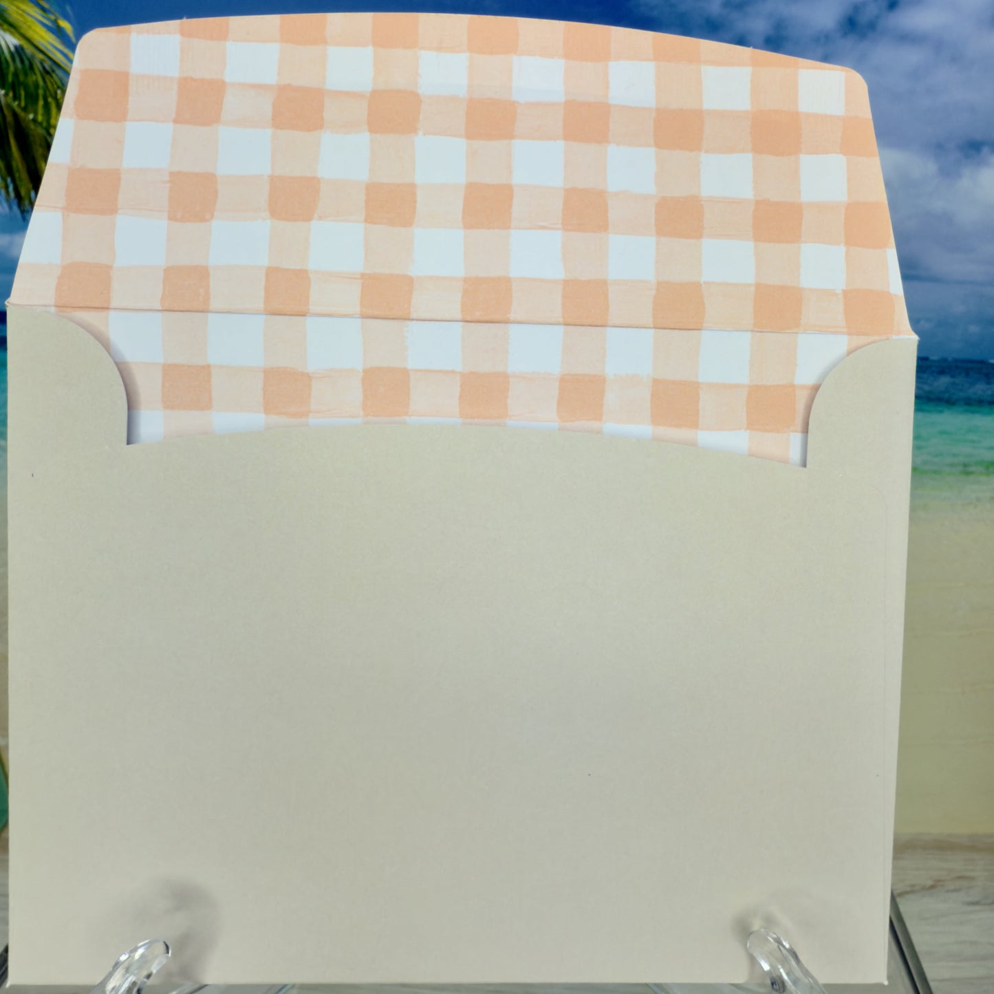 Envelope of a Happy-Easter greeting card with two fluffy bunnies nestled among floral designs from Pineapples and Palm Trees