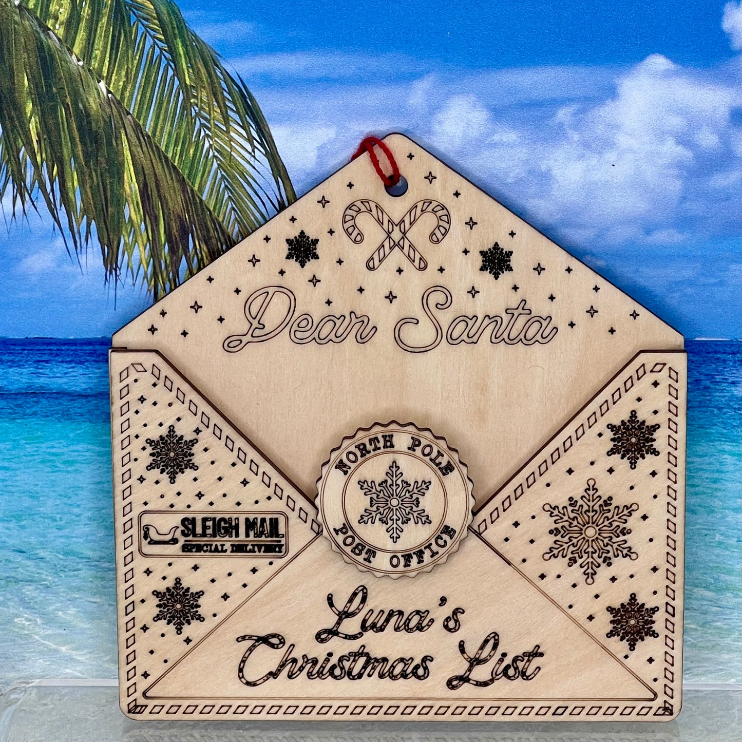 Lasered Christmas ornament shaped like an envelope with “Dear Santa” message, perfect for holiday décor.