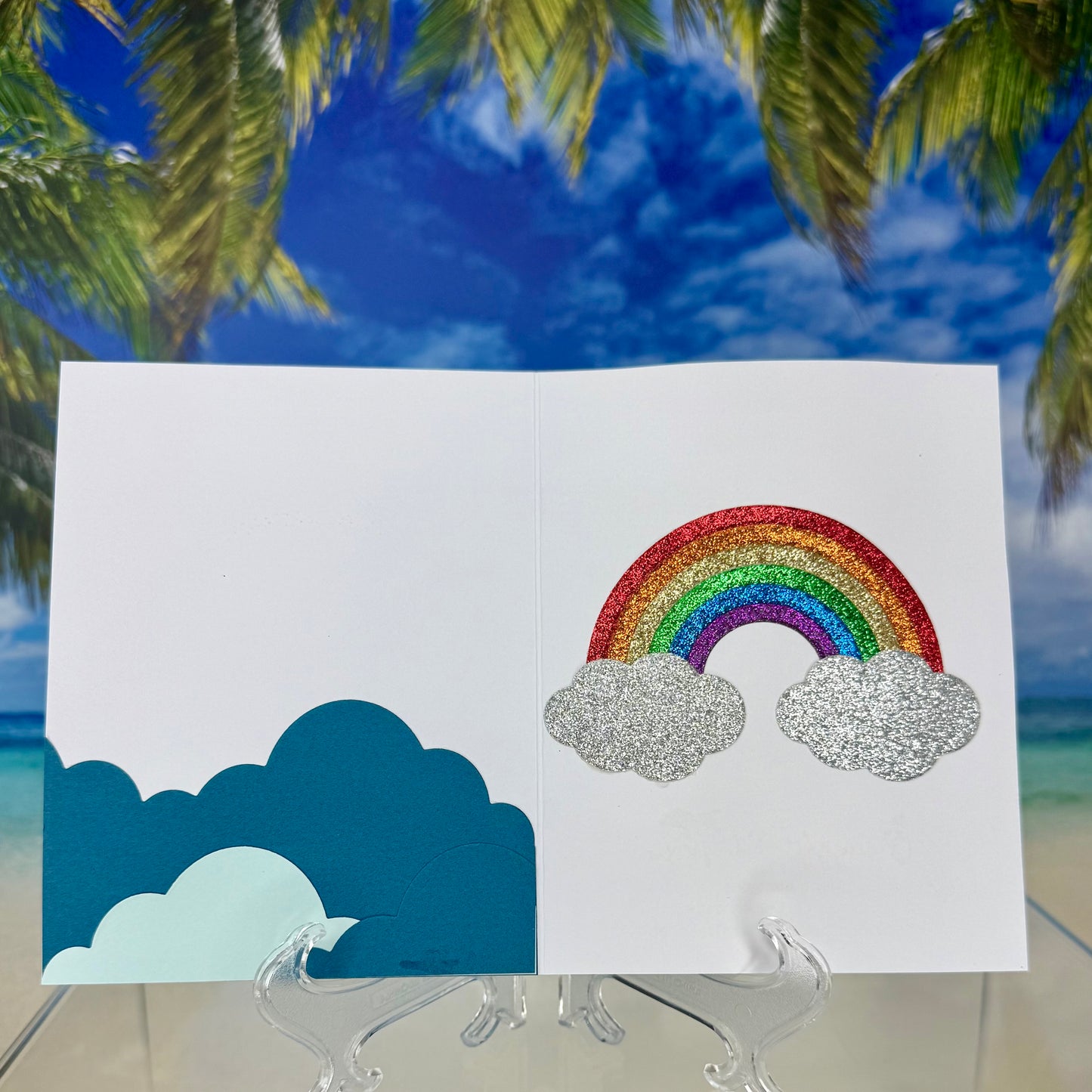 Inside view of “Rainbow Pattern & Clouds” greeting card showing blank interior for message.