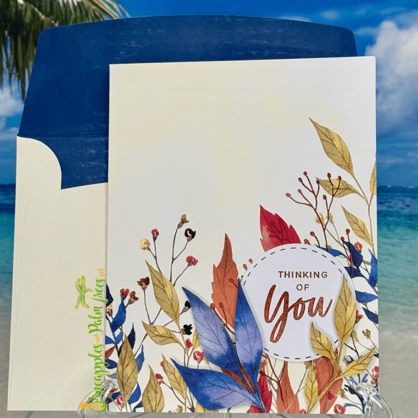 Greeting card “Thinking of You” with blue leaves illustration on the front cover.