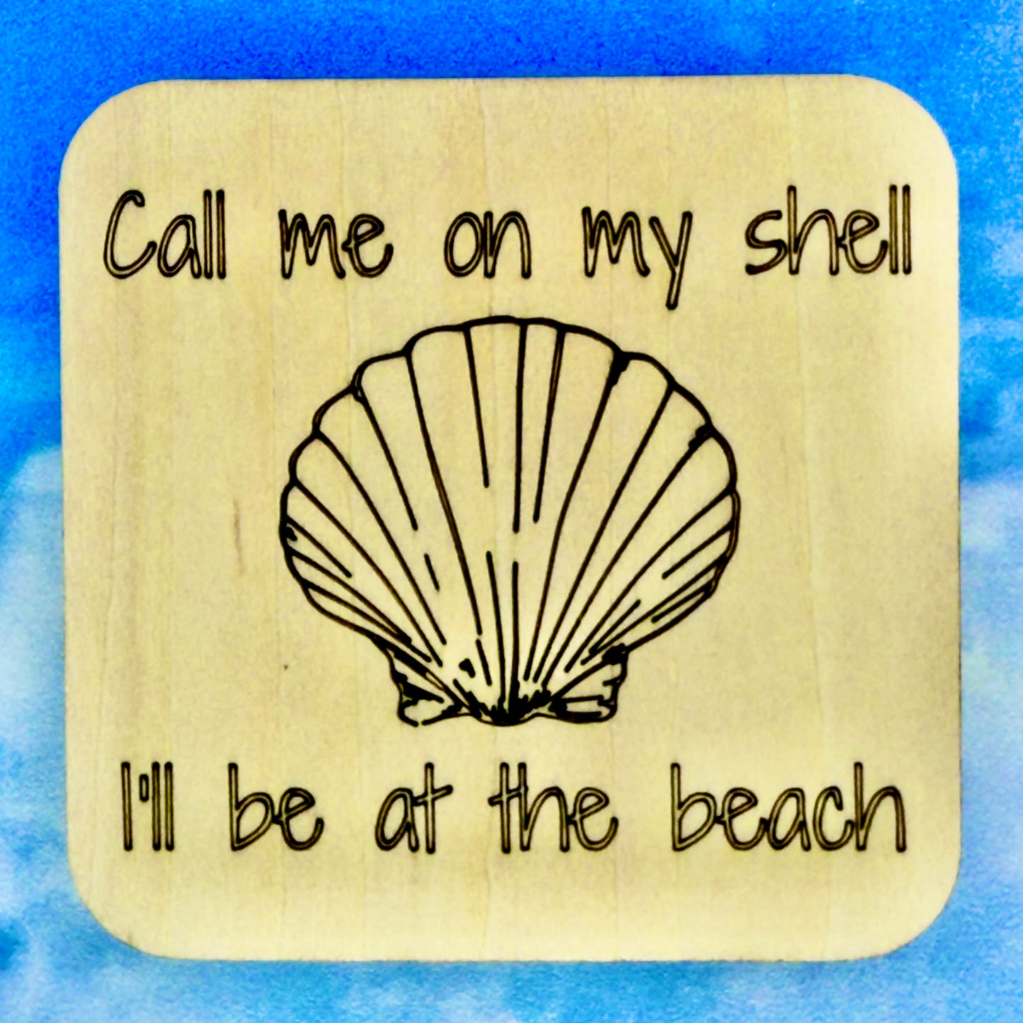 2.5" basewood square with “Call me on my shell I'll be at the ocean“ laser engraved text, along with an image of a shell in the center.