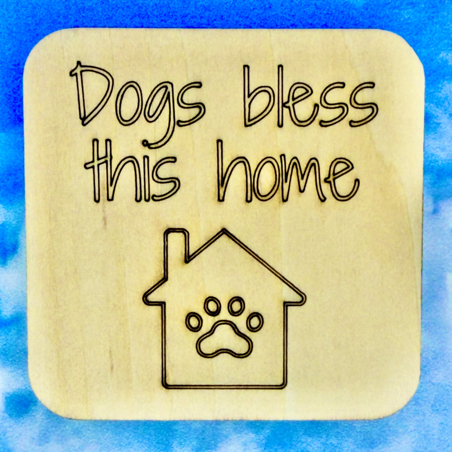 2.5" basewood square with “Dogs bless this home“ laser engraved text with image of dog house.