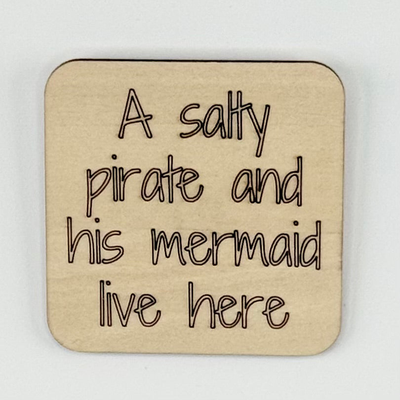 Fridge Magnet: A Salty Pirate and His Mermaid Live Here.