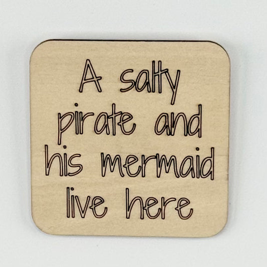 Fridge Magnet: A Salty Pirate and His Mermaid Live Here.