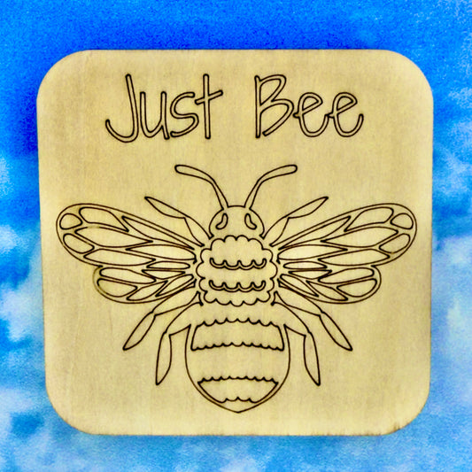 2.5" basewood square with “Just bee“ laser engraved text with image of a bee.