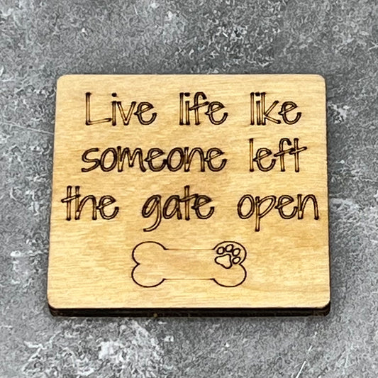 2" wood square with “Live life like someone left the gate open {dog bone}“ laser engraved