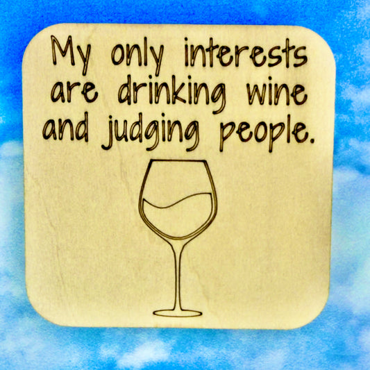 2.5" basewood square with “My only interests are drinking wine and judging people“ laser engraved text with image of wine glass.