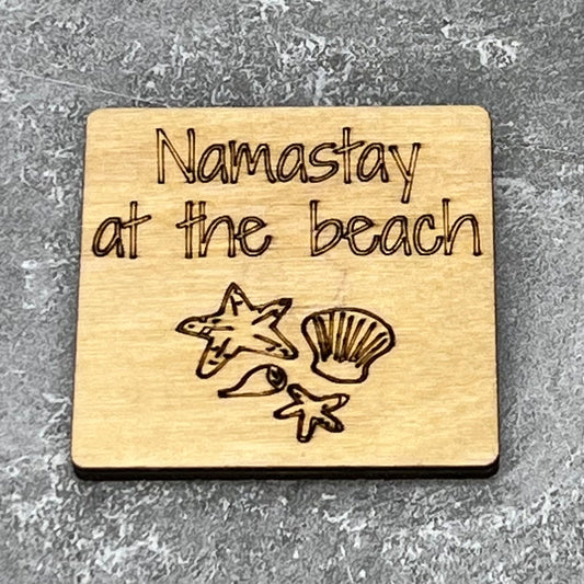 2" wood square with “Namastay at the beach {sea shells}“ laser engraved