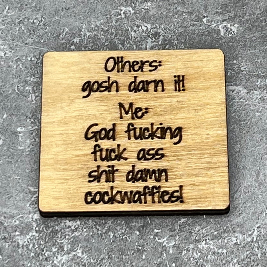 2" wood square with “Others: Gosh darn it! Me? God fucking fuck ass shit damn cockwaffles!“ laser engraved