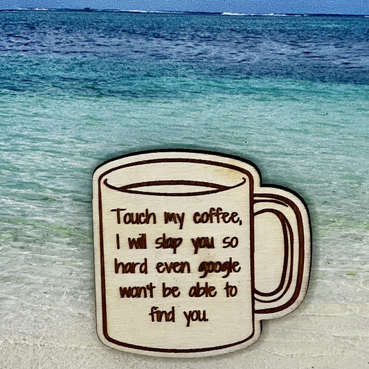 Wood outline of a coffee mug with “Touch My Coffee, I Will Slap You So Hard Even Google Won't Be Able to Find You.“ laser engraved. Background scene is a tropical ocean.