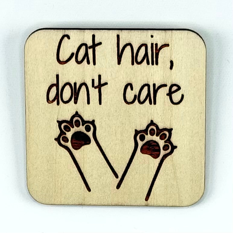 Laser-cut wooden fridge magnet engraved with the quote ‘Cat Hair, Don’t Care!’ — handcrafted and humorous décor for passionate cat owners.