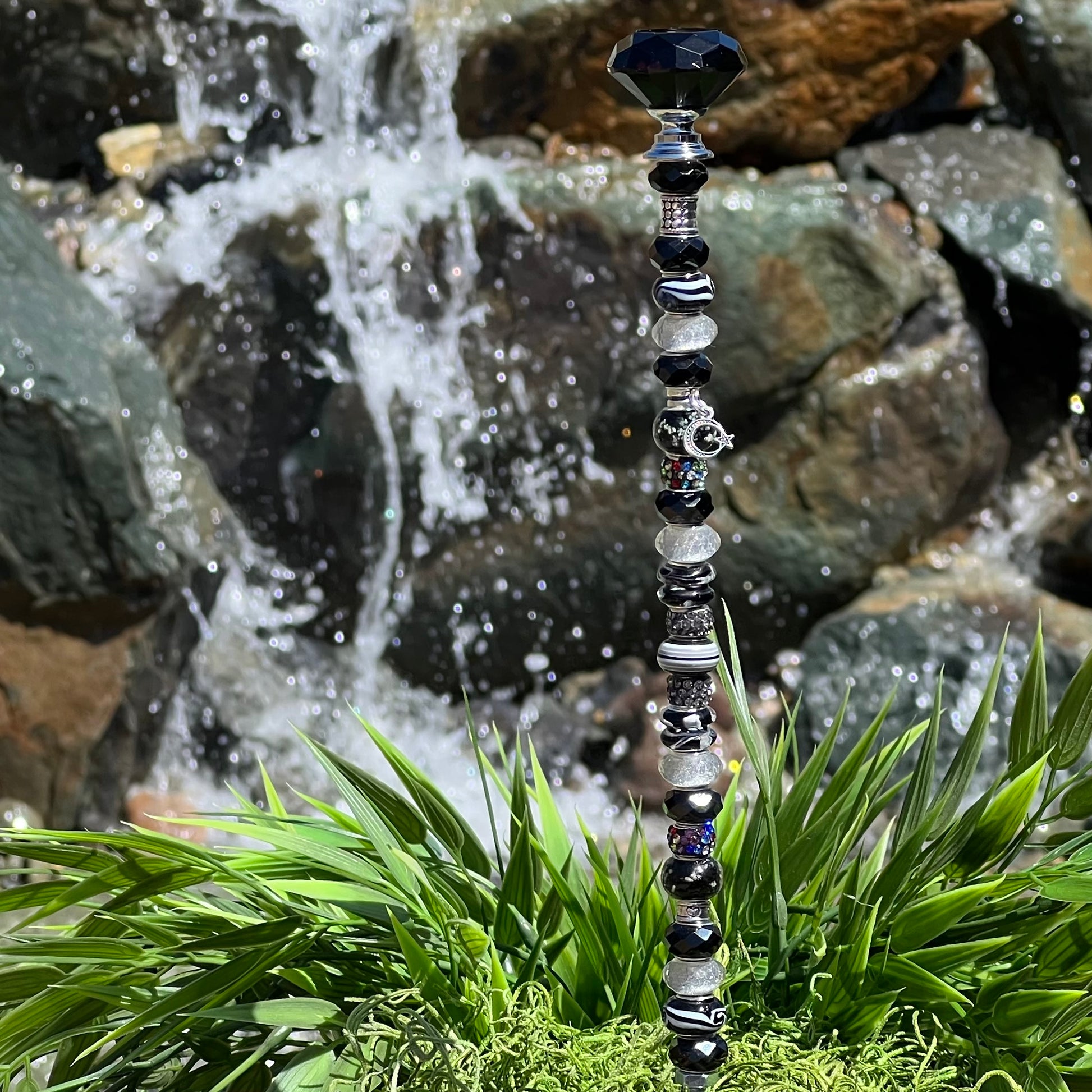 Black and white metal garden stake with moonlit starry night design — celestial outdoor décor.
