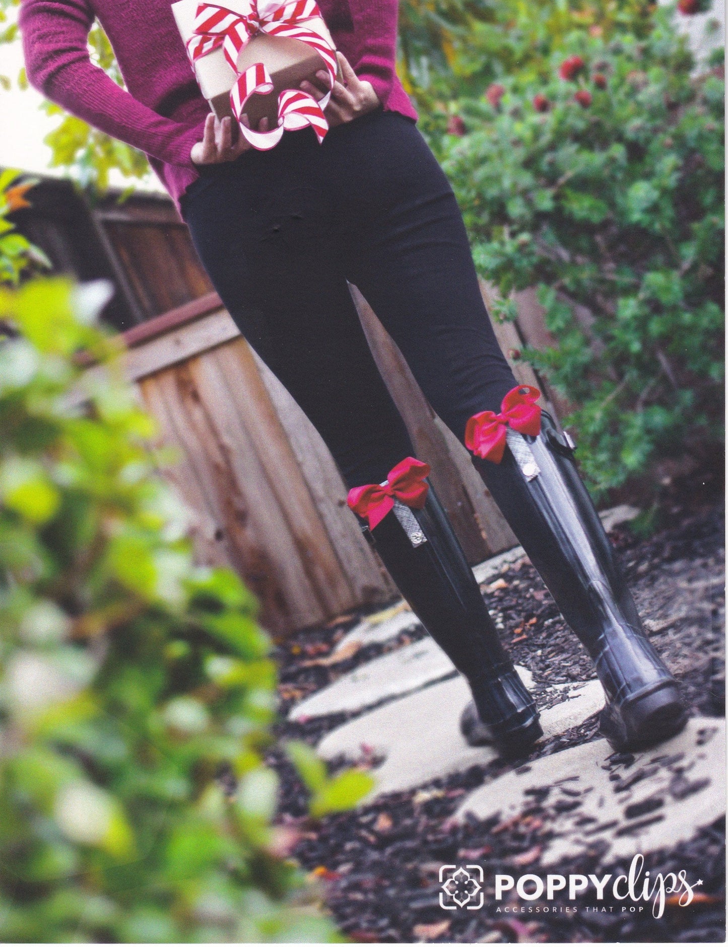 Woman wearing boots with a red BootClip accessory from Pineapples and Palm Trees, showcasing its bold and stylish design.