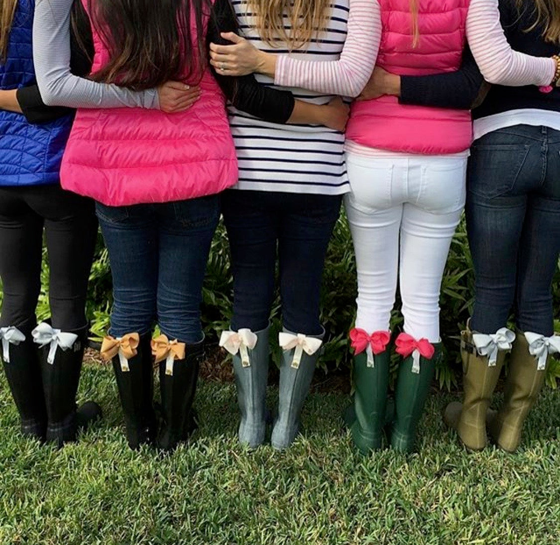 Group of women wearing stylish BootClips from Pineapples and Palm Trees, showing different colors on their boots.