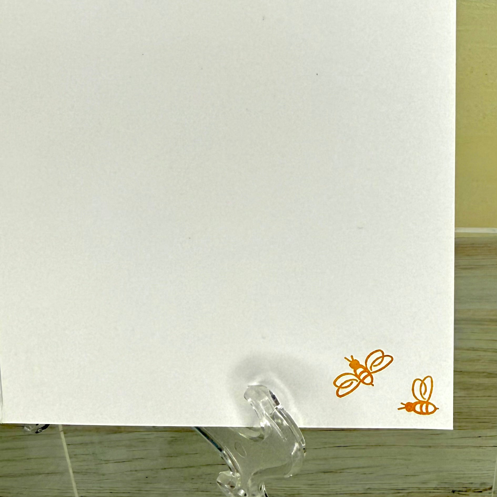 Back of greeting card showing two cute bees in the corner.