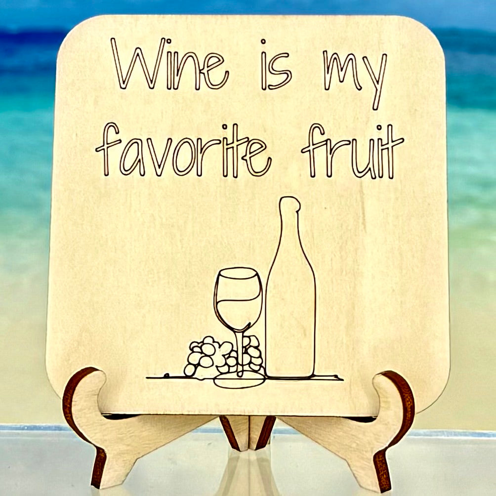 Fridge magnet with quote ‘Wine is my favorite fruit’ featuring wine bottle, glass, and grapes — funny wine lover decor.