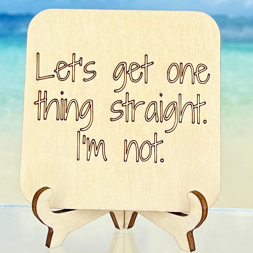 Wood-style fridge magnet: ‘Let’s get one thing straight — I’m not’ — humorous queer pride quote.
