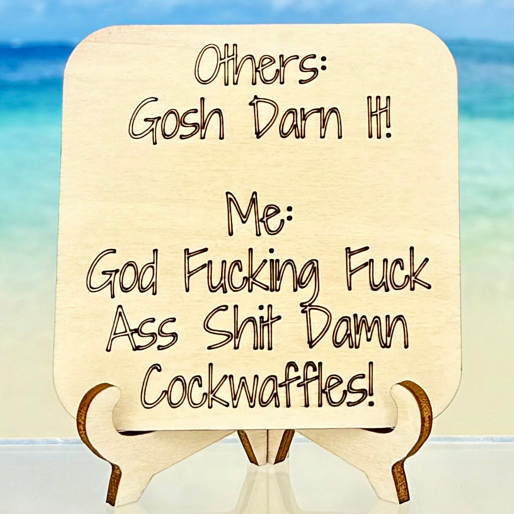 Laser-cut wooden fridge magnet engraved with a humorous string of swears: ‘Others: gosh-darn it. Me: god-fucking-fuck-ass-shit-damn-cockwaffles’ — handcrafted décor piece with strong magnet backing, for fans of bold humor.