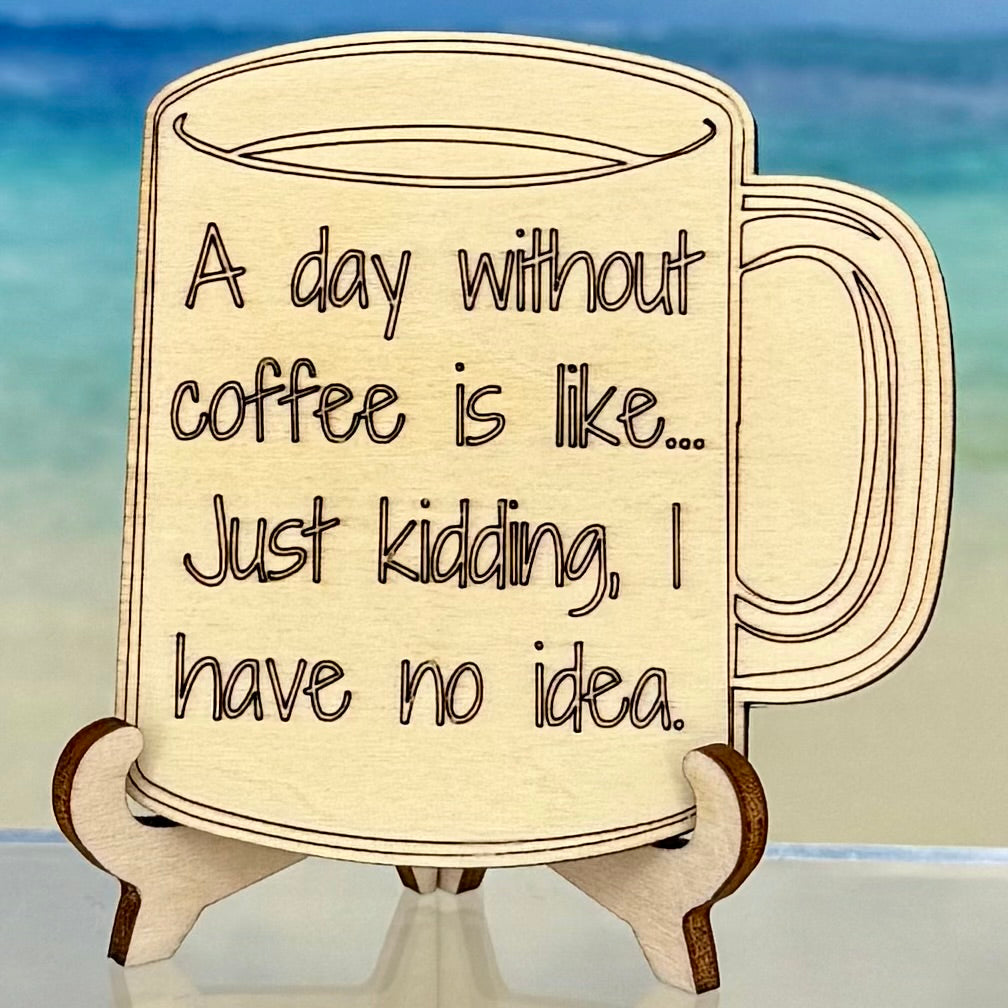 Laser-cut wooden fridge magnet engraved with the quote ‘A day without coffee is like… just kidding, I have no idea!’ — handcrafted with a strong magnet back, ideal for coffee lovers and humor-filled kitchen décor.