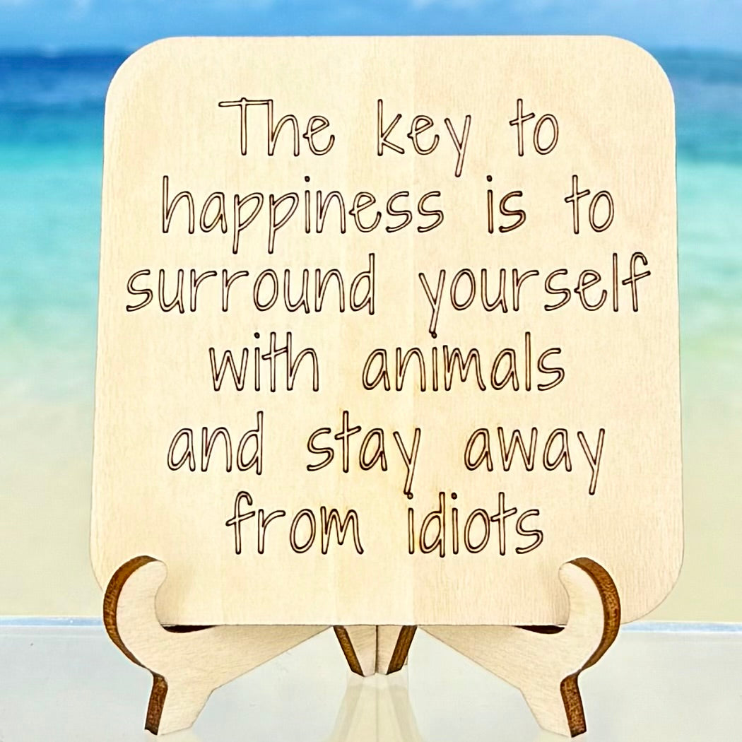 Wooden fridge magnet engraved with the quote ‘The key to happiness is to surround yourself with animals and stay away from idiots’ — handcrafted with laser-cut design and strong magnet backing.