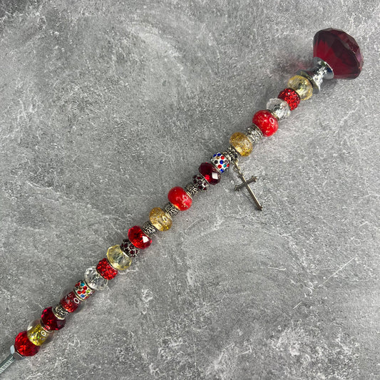 Crimson metal garden stake in the shape of a cross — inspirational Christian yard décor.
