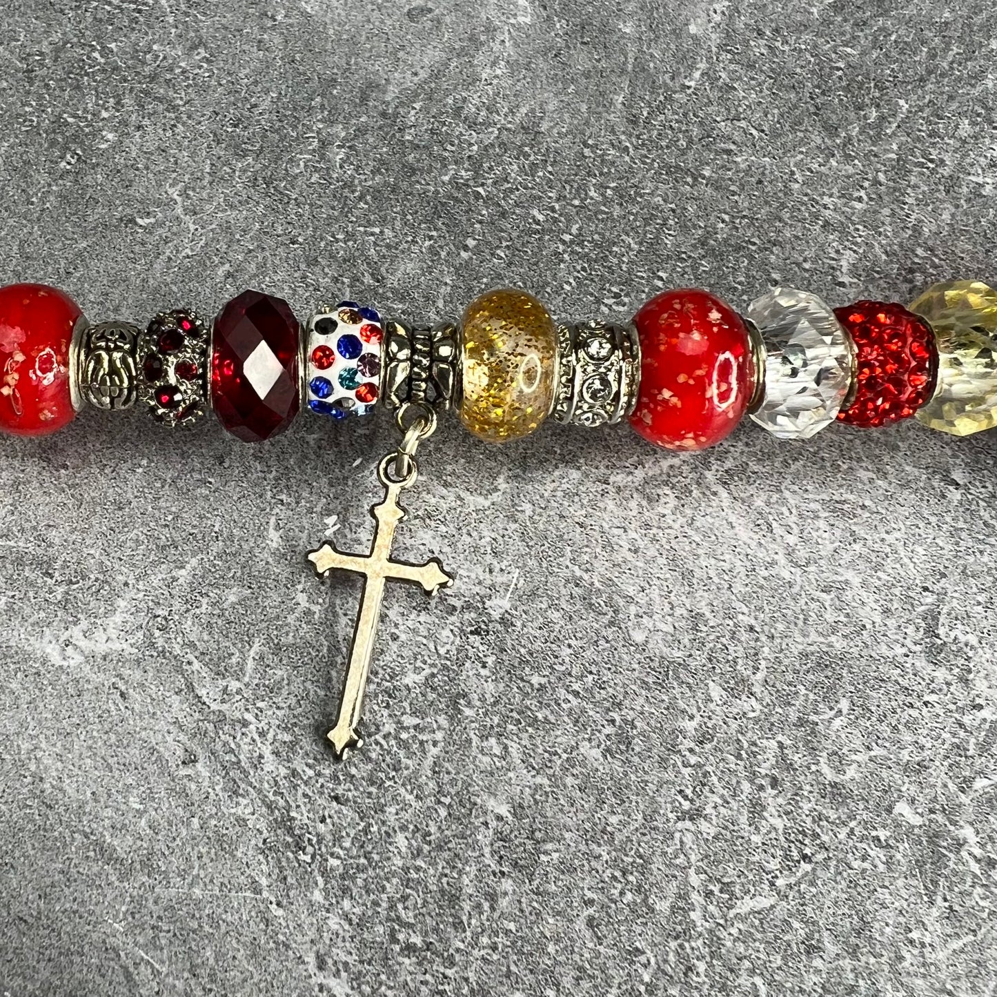 Crimson metal garden stake shaped like a cross — Christian yard décor.