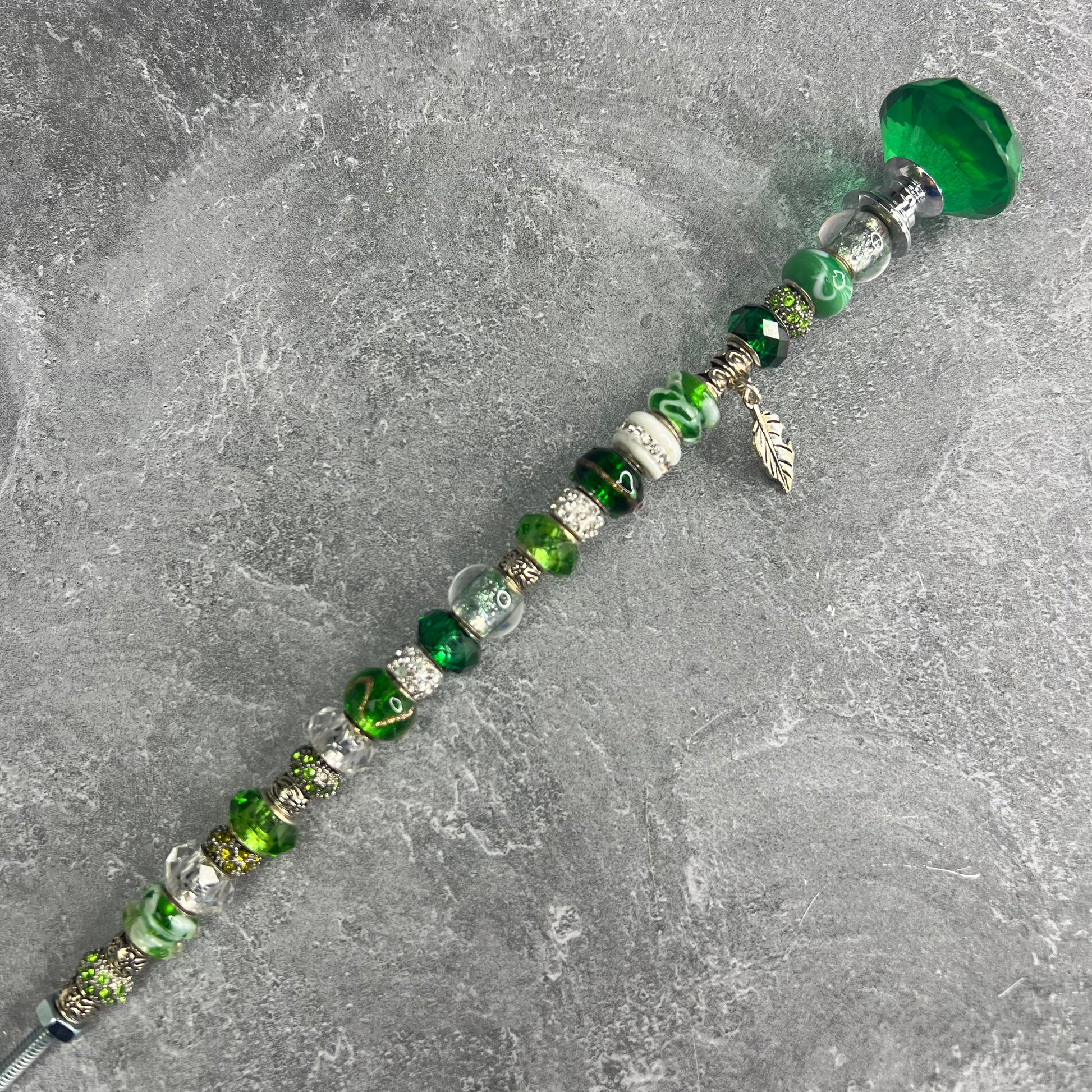 Emerald green garden stake with a canopy/tree design — decorative metal yard décor for a lush garden.