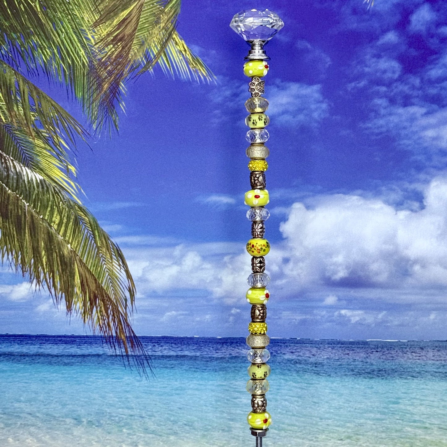 Yellow metal garden stake with paw print and ‘Pawsitive Vibes’ — cheerful pet-themed outdoor décor.
