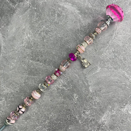 Pink castle-shaped metal garden stake — fairy-tale outdoor décor for a charming garden Oasis.
