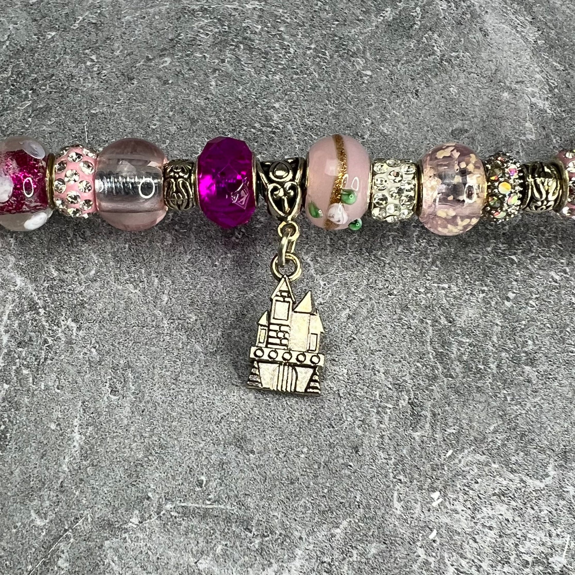 Pink metal garden stake in the shape of a castle — whimsical oasis-themed outdoor décor.
