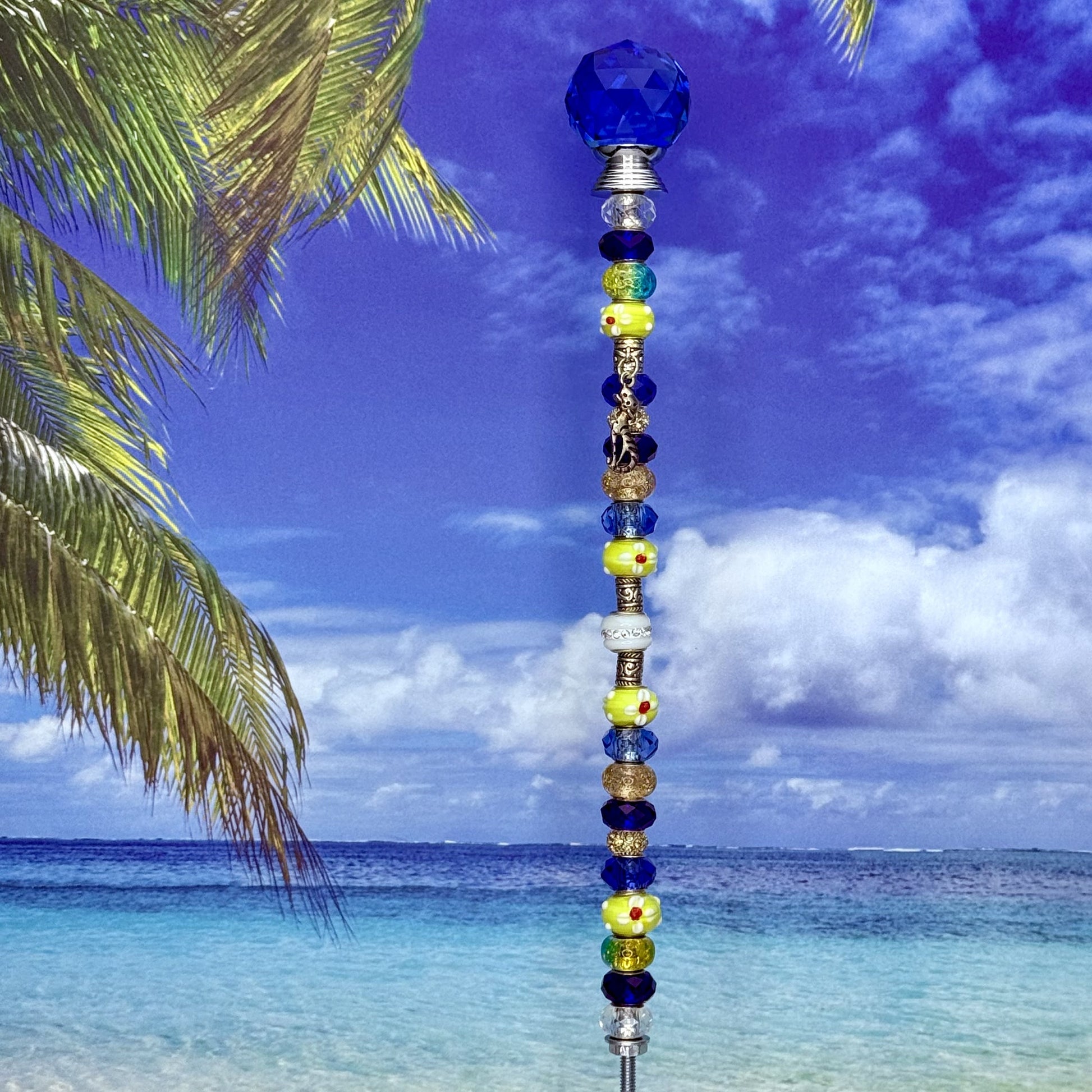 Blue metal garden stake with a sunny cat silhouette — whimsical pet‑themed outdoor décor.
