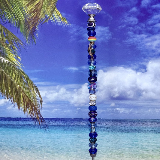 Blue metal garden stake with seahorse design — nautical and coastal outdoor décor.
