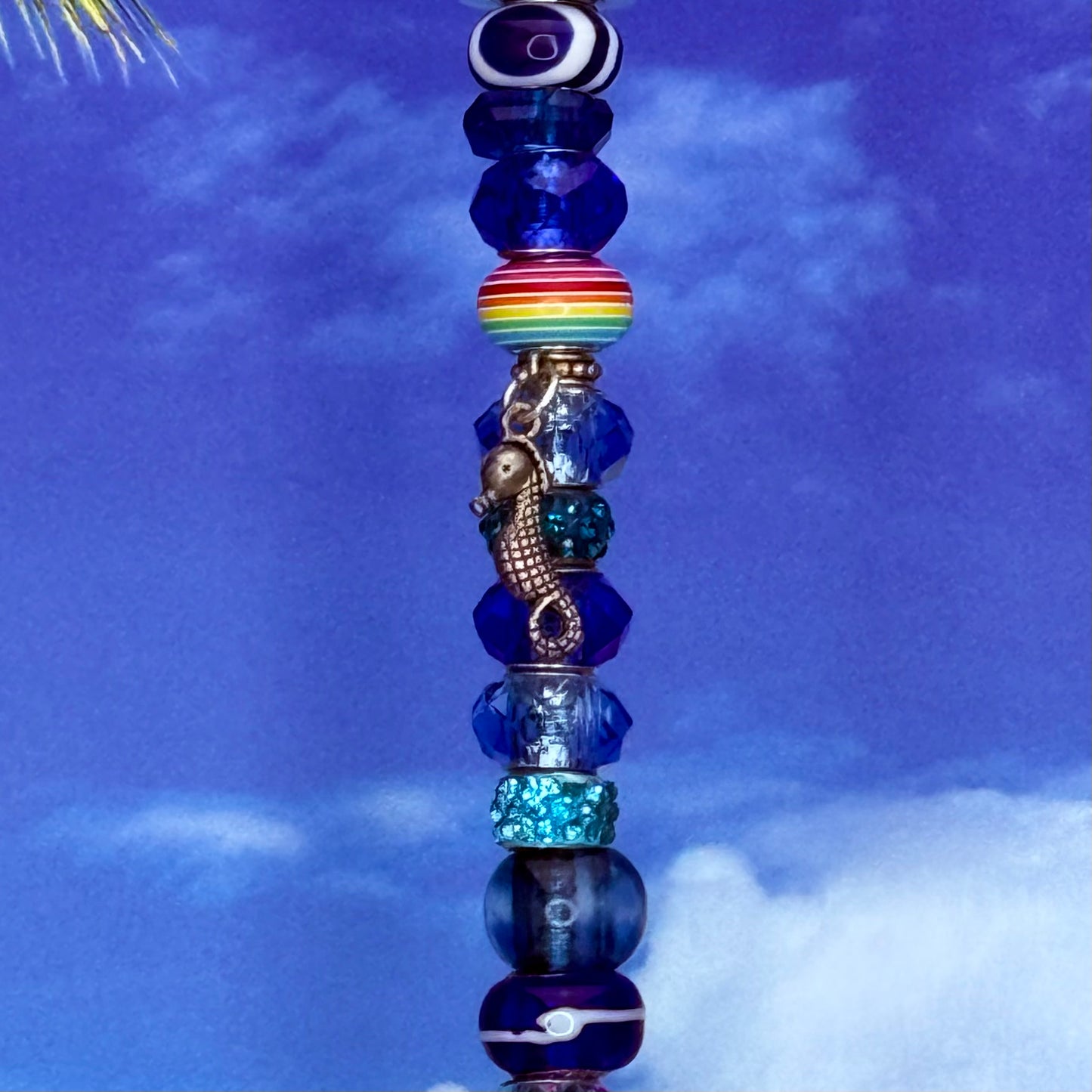 Blue metal garden stake with seahorse design — nautical and coastal outdoor décor.
