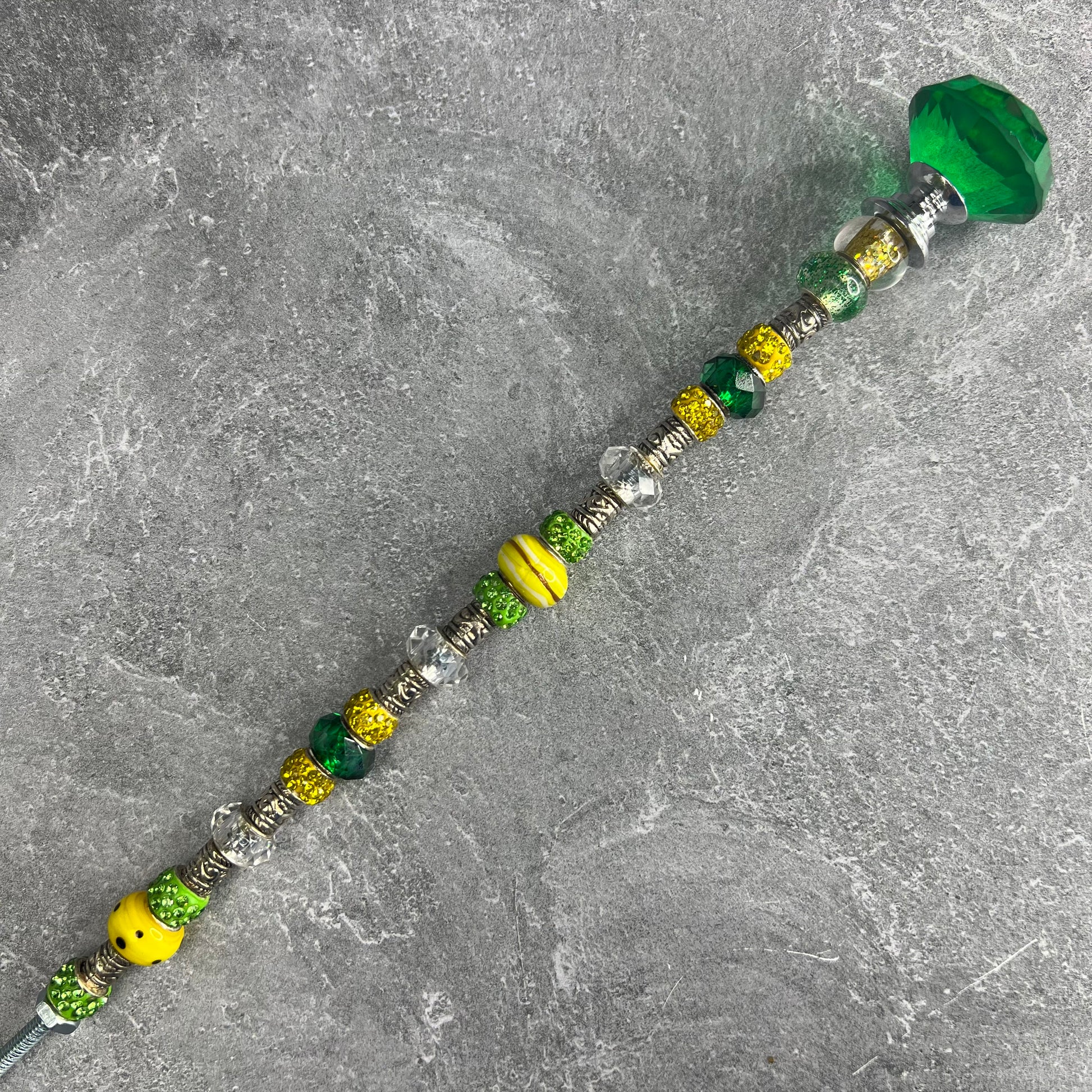 Green and yellow metal garden stake ‘Sunlit Emerald Radiance’ — elegant outdoor yard décor.